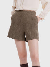 You can wear woolen shorts with a V-neck sweater.